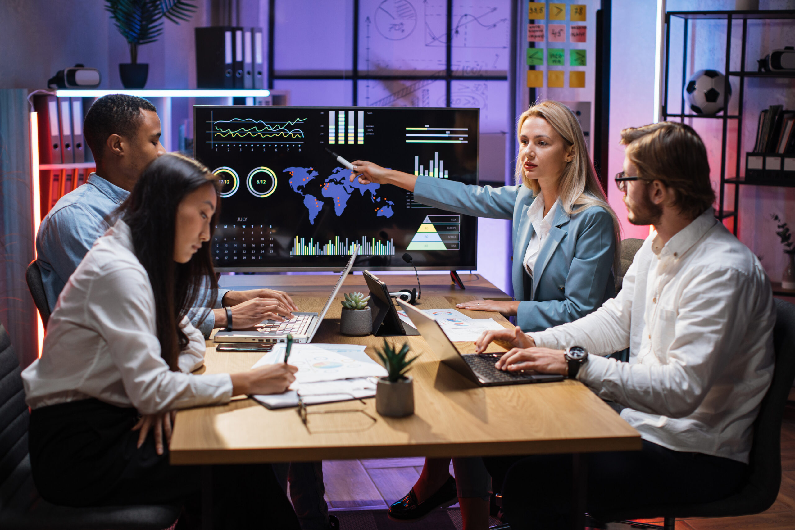 multiracial partners discussing financial project at office