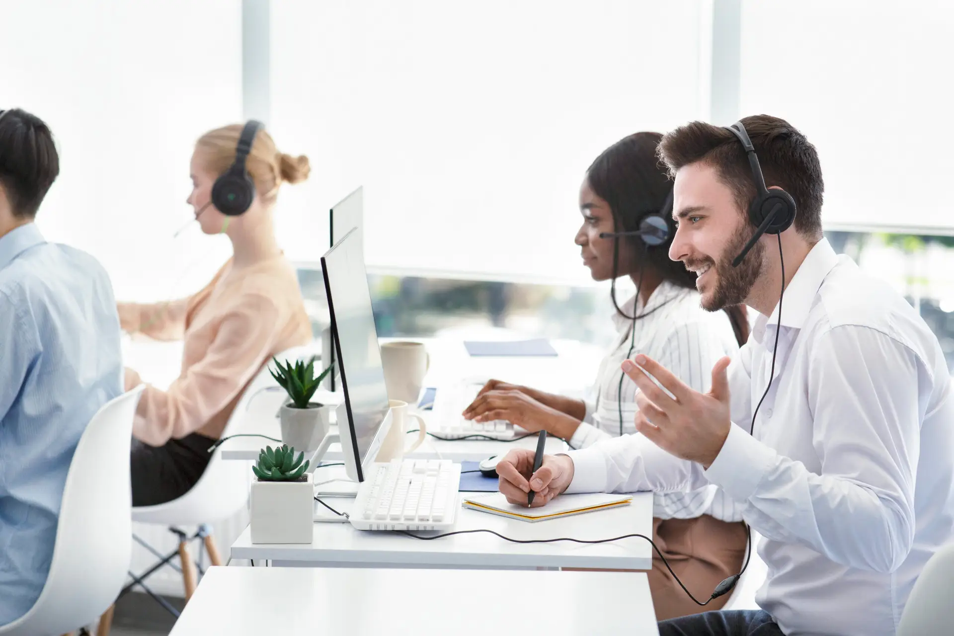 customer service representatives assisting clients, resolving technical issues or selling products at call centre